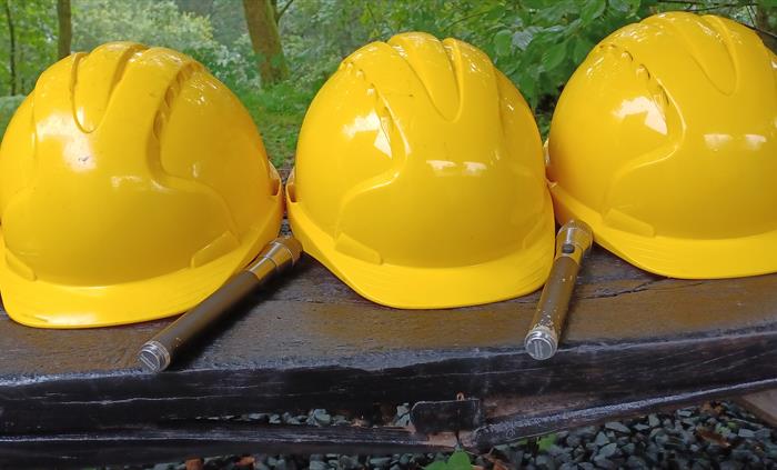 Yellow hard helmets and hand torches